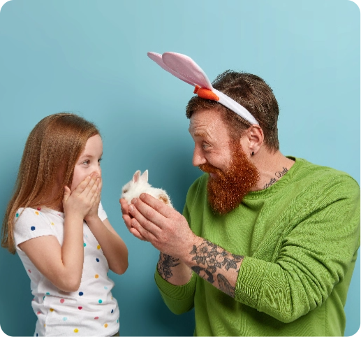 happy-father-gives-small-fluffy-rabbit-to-his-daughter-makes-present@2x